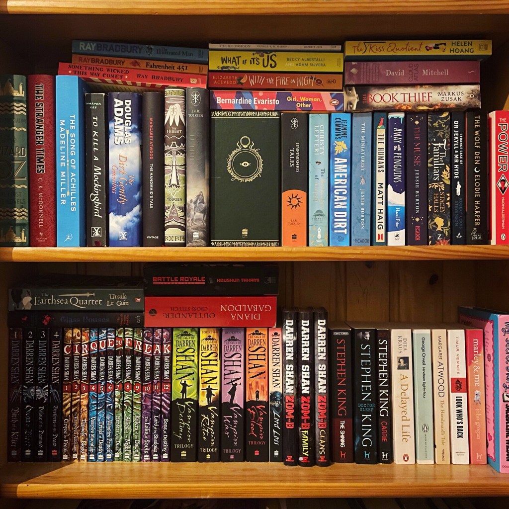 Two book shelves stacked full with 
a variety of colourful books. Overlayed on the image is a red box with the words 'Contact me'.